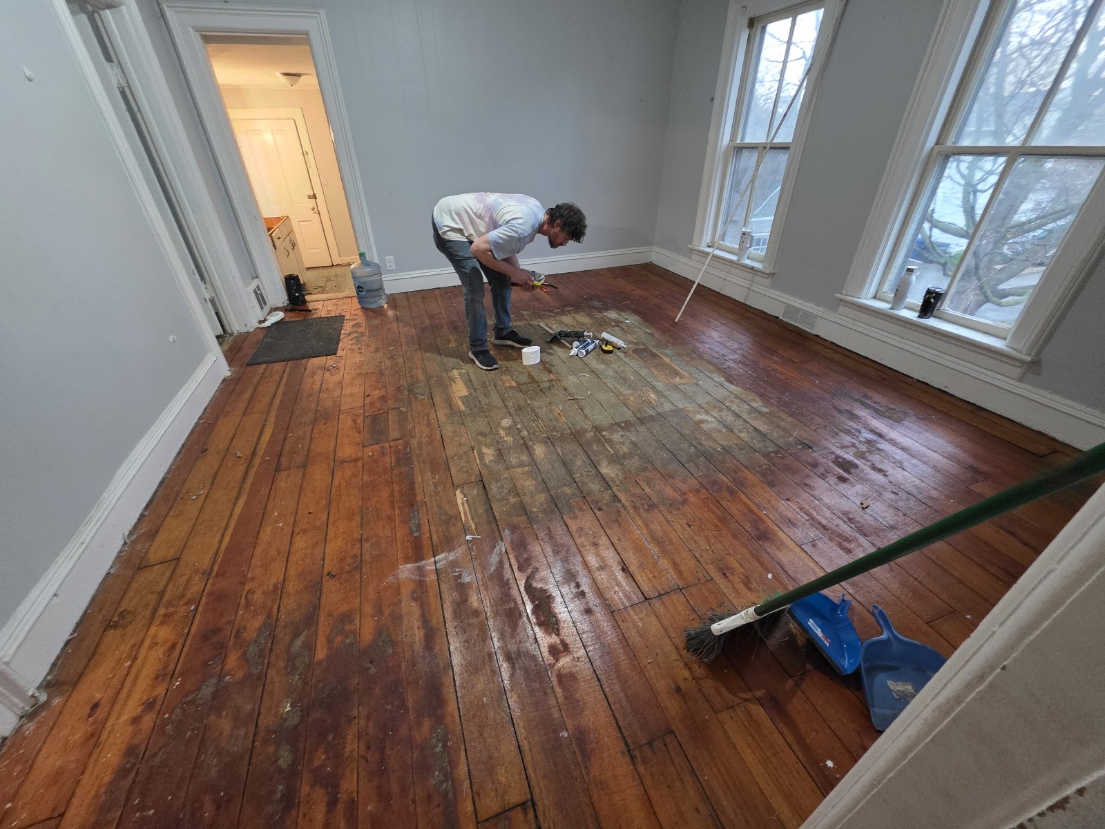Cody refinishing a hardwood floor in Oshkosh